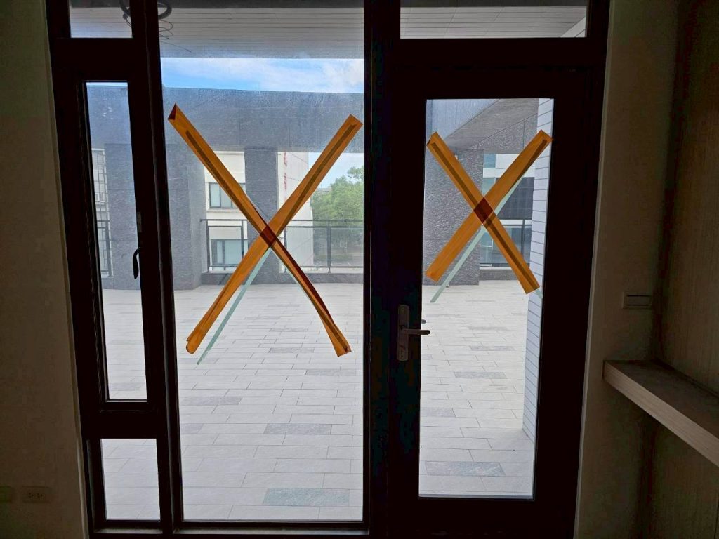 清潔前：窗戶貼有施工膠帶，玻璃表面霧濛濛。